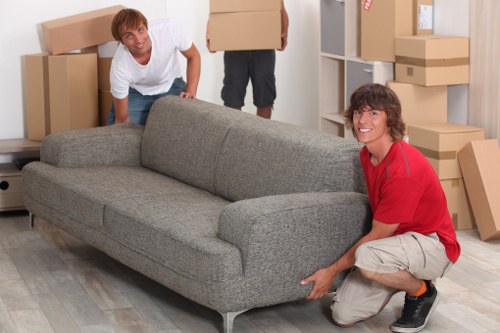 Local movers handling packed boxes during a Crystal Palace relocation